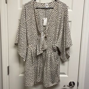 Kimono sleeved romper with keyhole tie in front.